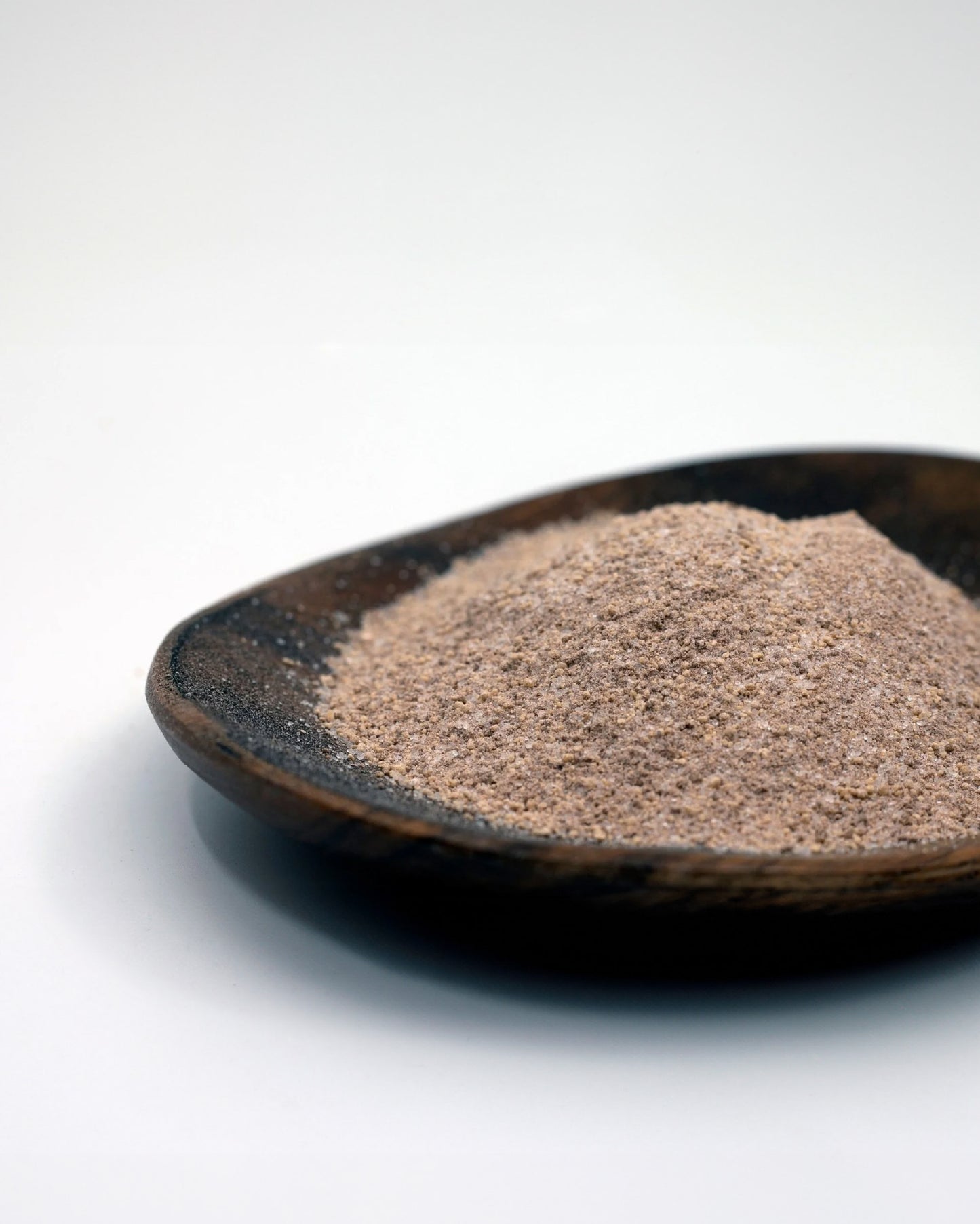 Close-up picture of Cinnamon Toast Swirl seasoning on a wooden dish.