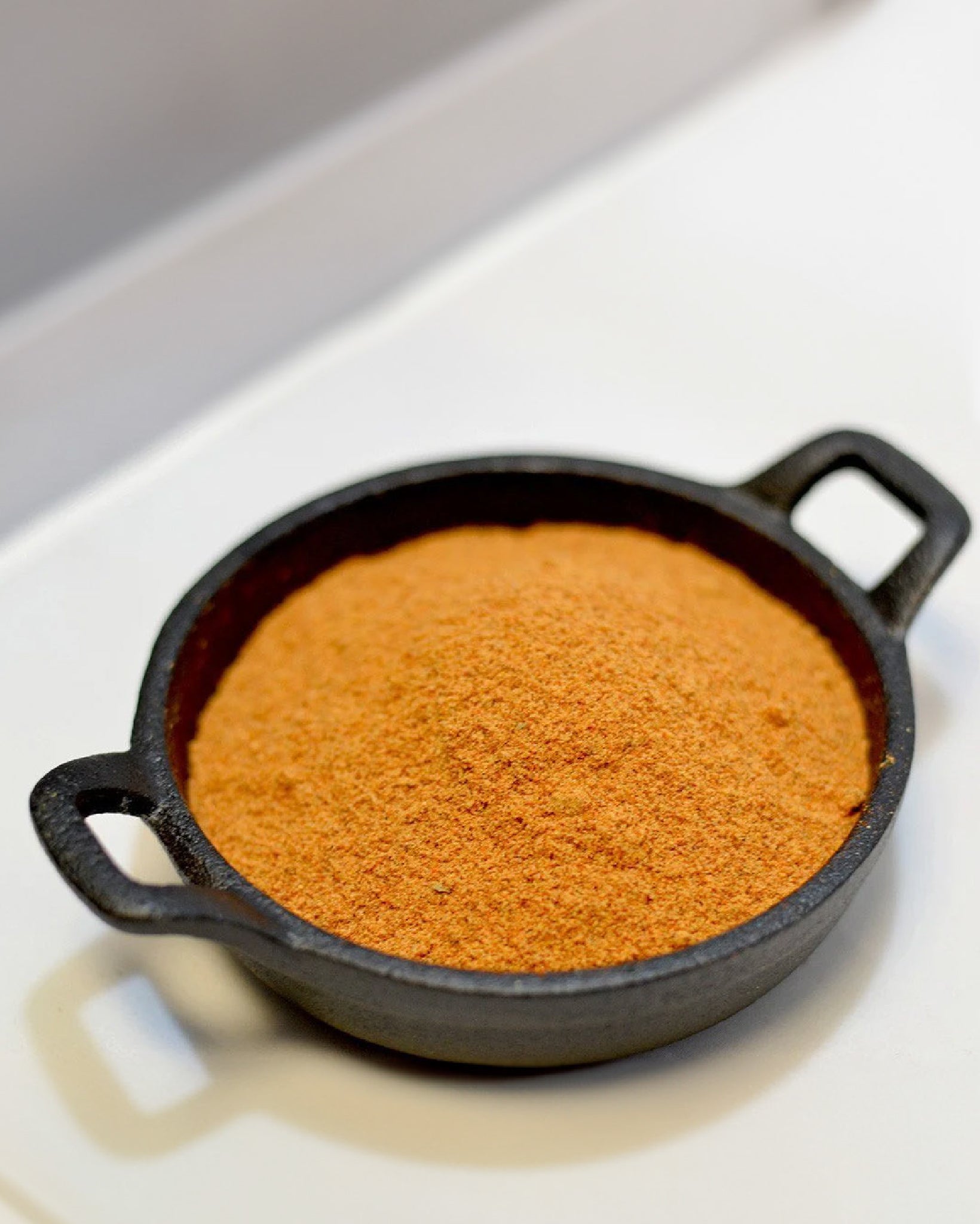 Close-up picture of Fiery Sriracha seasoning in a mini cast-iron pan.