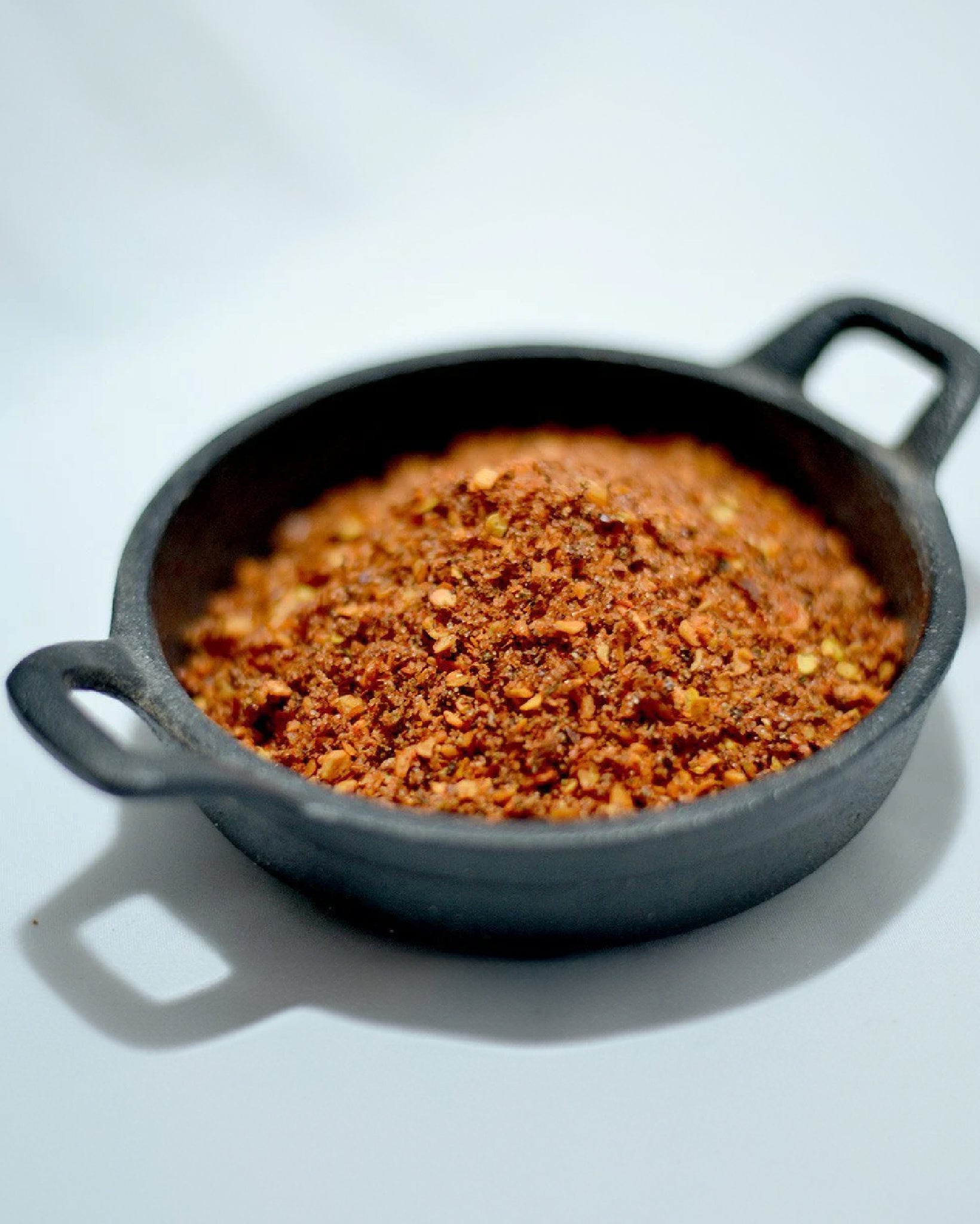 Close-up picture of Vampire Slayer seasoning in a mini cast iron pan.